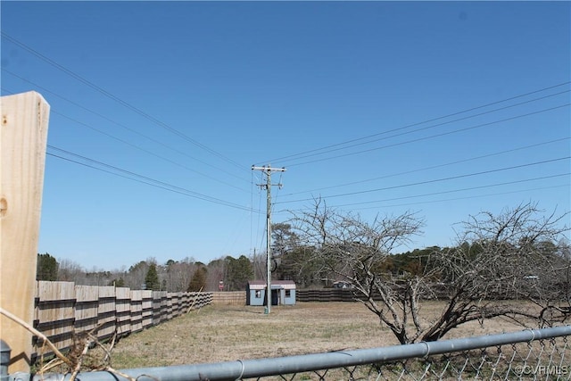 view of yard with an outbuilding and fence