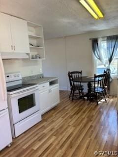 kitchen with white range with electric cooktop, white cabinets, open shelves, and wood finished floors