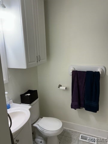 bathroom with vanity, toilet, baseboards, tile patterned floors, and visible vents