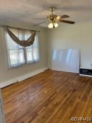empty room featuring a ceiling fan and wood finished floors