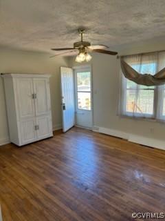 empty room featuring a textured ceiling, wood finished floors, and a ceiling fan