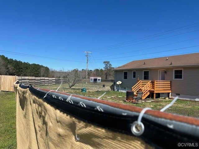 view of front of home featuring fence and a wooden deck