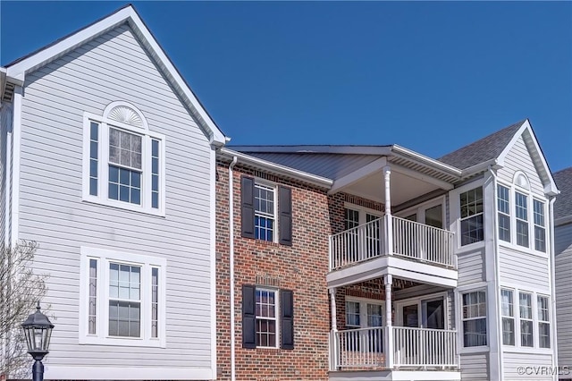 view of property exterior with brick siding