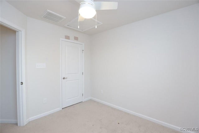 empty room with light carpet, baseboards, visible vents, and attic access