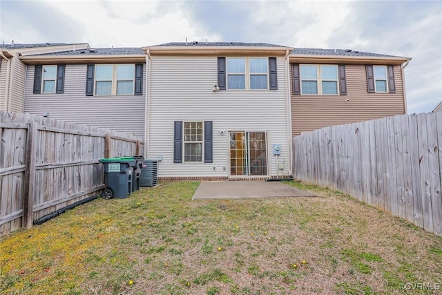 rear view of property with central air condition unit, a fenced backyard, a patio, and a yard