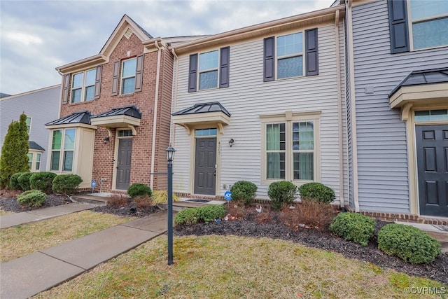 townhome / multi-family property with brick siding