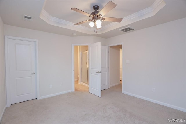 unfurnished bedroom with baseboards, a raised ceiling, visible vents, and crown molding