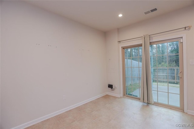 spare room featuring recessed lighting, visible vents, and baseboards