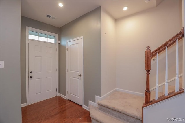 foyer with baseboards, stairs, visible vents, and recessed lighting