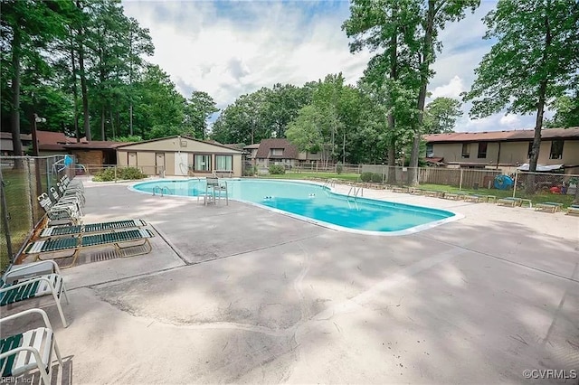 pool featuring fence and a patio