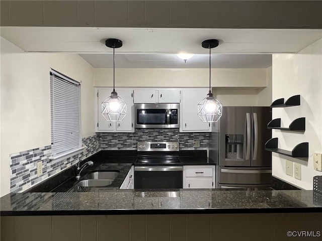 kitchen with tasteful backsplash, a peninsula, stainless steel appliances, white cabinetry, and a sink