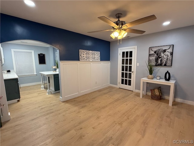 interior space featuring arched walkways, ceiling fan, light wood finished floors, and recessed lighting