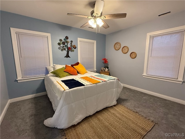 carpeted bedroom featuring visible vents, baseboards, and a ceiling fan