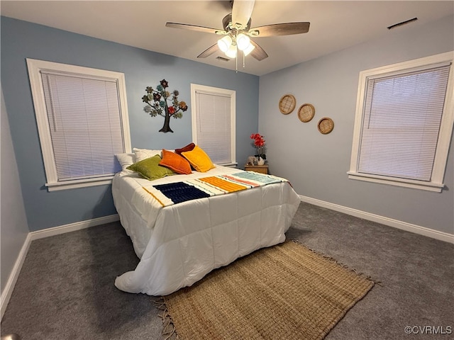 bedroom with ceiling fan, carpet flooring, visible vents, and baseboards