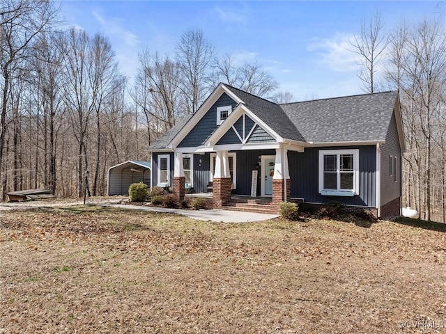 craftsman house featuring a porch, a carport, board and batten siding, and a shingled roof