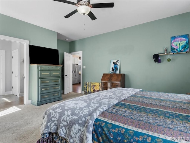 bedroom with baseboards, washer / clothes dryer, stainless steel fridge with ice dispenser, ceiling fan, and light colored carpet