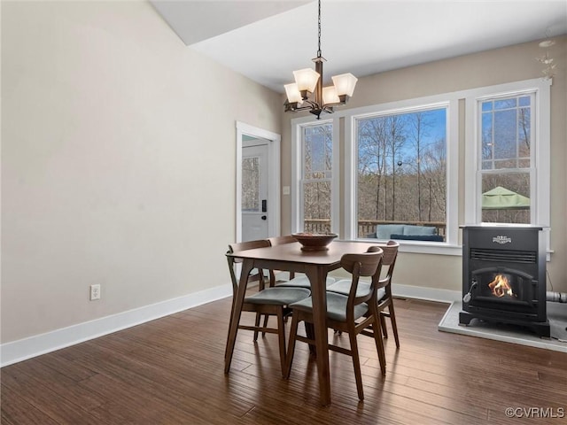 dining room with an inviting chandelier, baseboards, and dark wood-style flooring