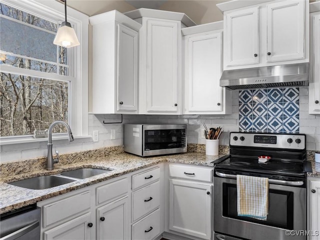 kitchen with backsplash, stainless steel appliances, exhaust hood, white cabinetry, and a sink