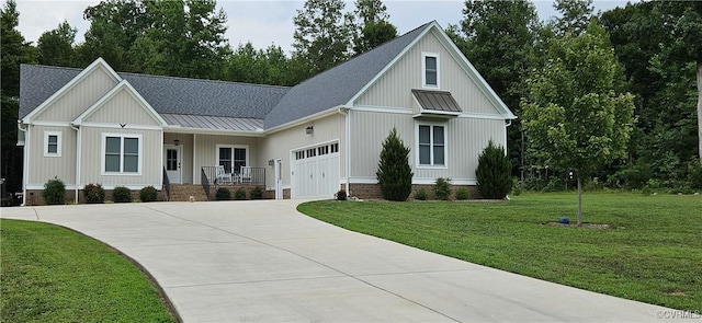 modern inspired farmhouse with a porch, a front yard, a garage, driveway, and a standing seam roof