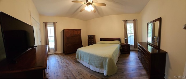 bedroom with vaulted ceiling, baseboards, ceiling fan, and dark wood-style flooring