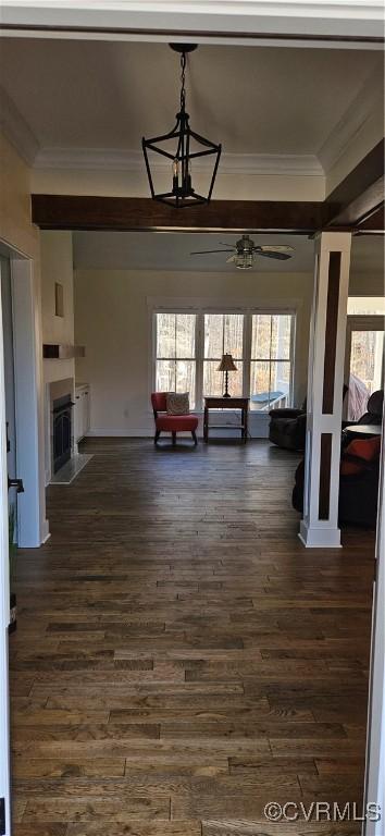 unfurnished living room featuring a fireplace, dark wood-style floors, and crown molding