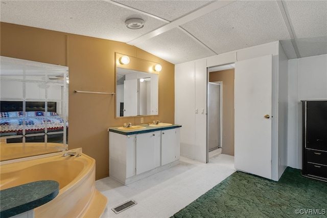 bathroom featuring vanity, visible vents, a stall shower, vaulted ceiling, and a bath