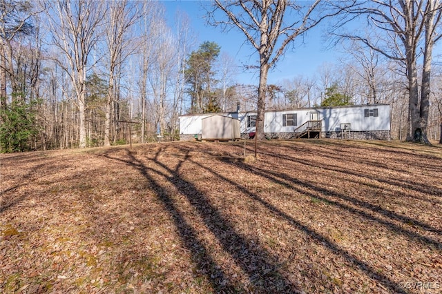 view of yard with an outdoor structure and a shed