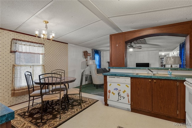 kitchen featuring wallpapered walls, ceiling fan with notable chandelier, white appliances, a textured ceiling, and a sink