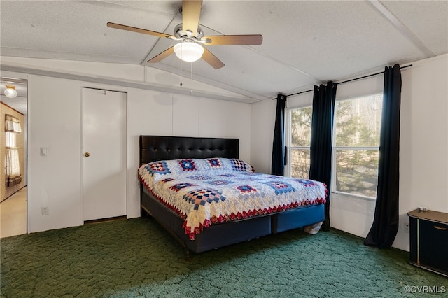 carpeted bedroom with ceiling fan, lofted ceiling, and a textured ceiling