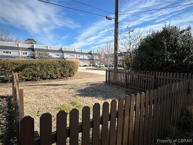 view of yard with a residential view and fence