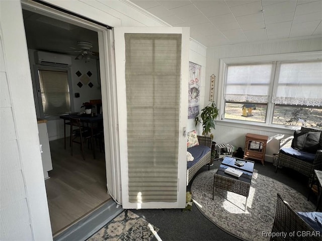 interior space featuring a ceiling fan and a wall mounted air conditioner