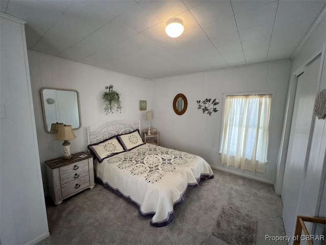 bedroom with baseboards and carpet flooring