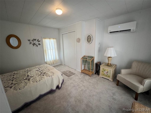 bedroom with an AC wall unit, a closet, and carpet