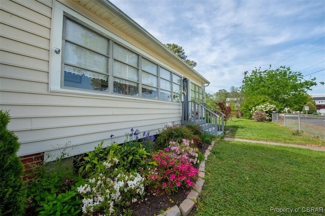 111 Taylor Ave, Urbanna, VA 23175 - view of side of home with a lawn and fence