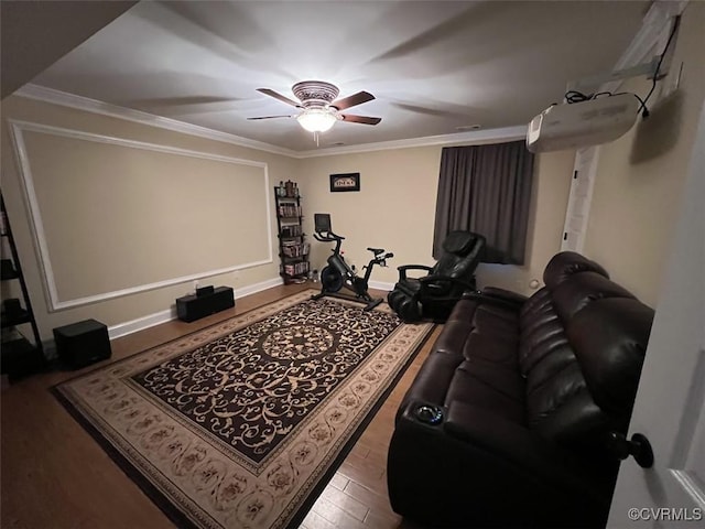 cinema featuring ceiling fan, ornamental molding, wood finished floors, and baseboards