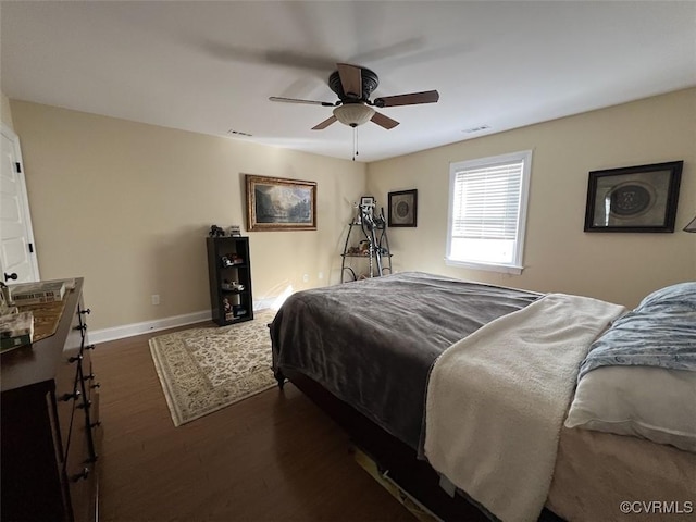 bedroom with ceiling fan, visible vents, baseboards, and dark wood-type flooring