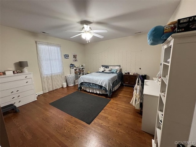 bedroom with a ceiling fan, visible vents, and wood finished floors