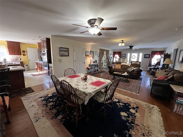 dining room with plenty of natural light, ceiling fan, and light wood-style flooring