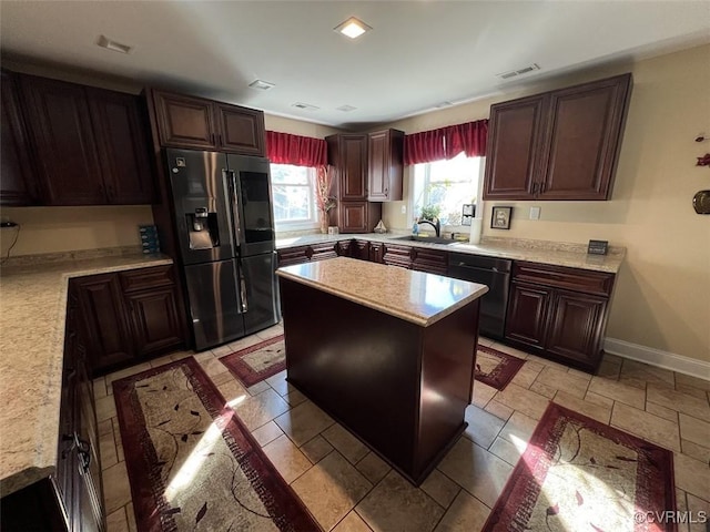 kitchen with baseboards, visible vents, dishwasher, refrigerator with ice dispenser, and a sink