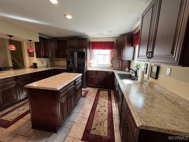 kitchen with a sink, dark brown cabinets, a kitchen island, and black fridge with ice dispenser