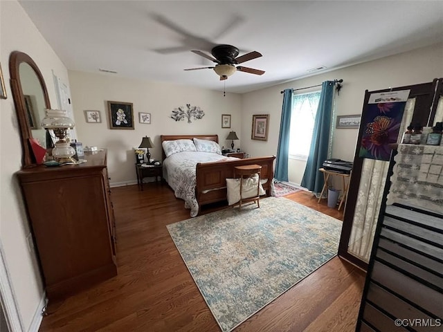 bedroom with ceiling fan, baseboards, and wood finished floors