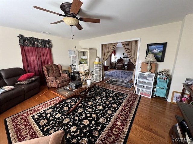 living area featuring a ceiling fan and wood finished floors