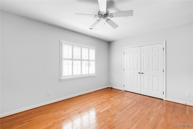 unfurnished bedroom featuring visible vents, a closet, light wood-style flooring, and baseboards