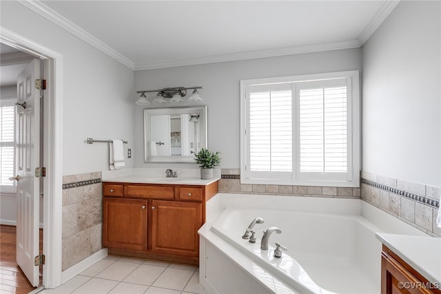 bathroom featuring tile patterned flooring, ornamental molding, a bath, and vanity