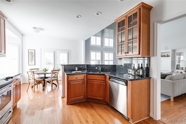 kitchen with a healthy amount of sunlight, appliances with stainless steel finishes, and brown cabinetry