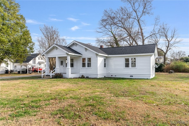 view of front of house featuring a front lawn, crawl space, a chimney, and a shingled roof