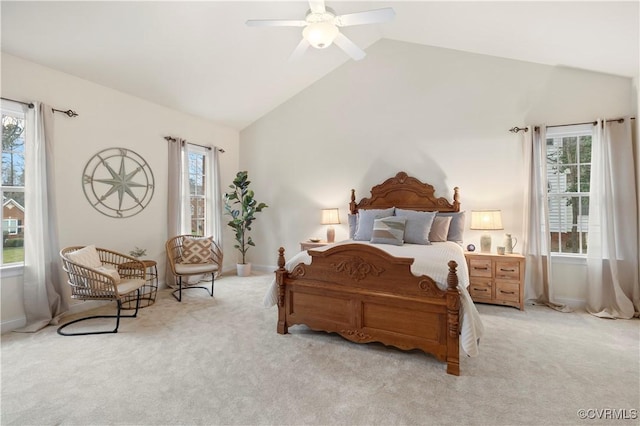 bedroom with a ceiling fan, light colored carpet, multiple windows, and baseboards