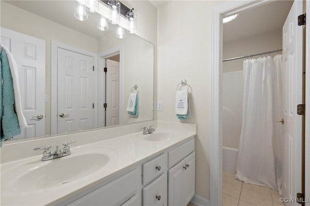 bathroom featuring double vanity, shower / tub combo, a sink, and tile patterned floors