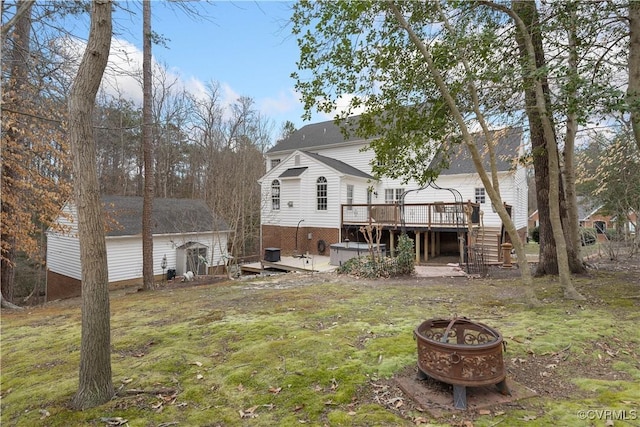 back of property with stairs, a yard, an outdoor fire pit, and a wooden deck