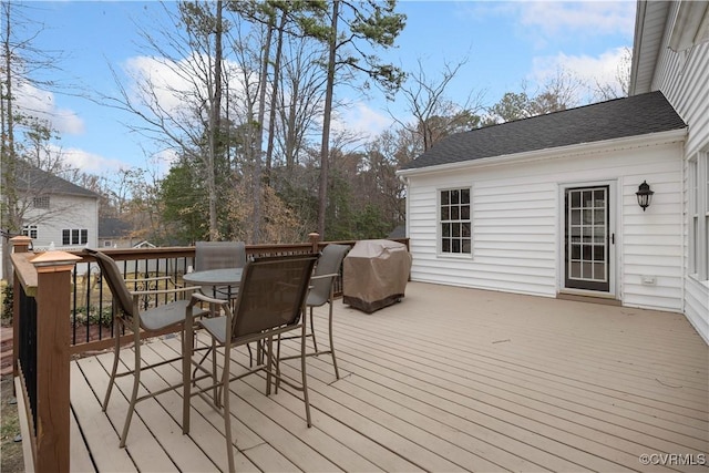 wooden deck featuring outdoor dining area and area for grilling